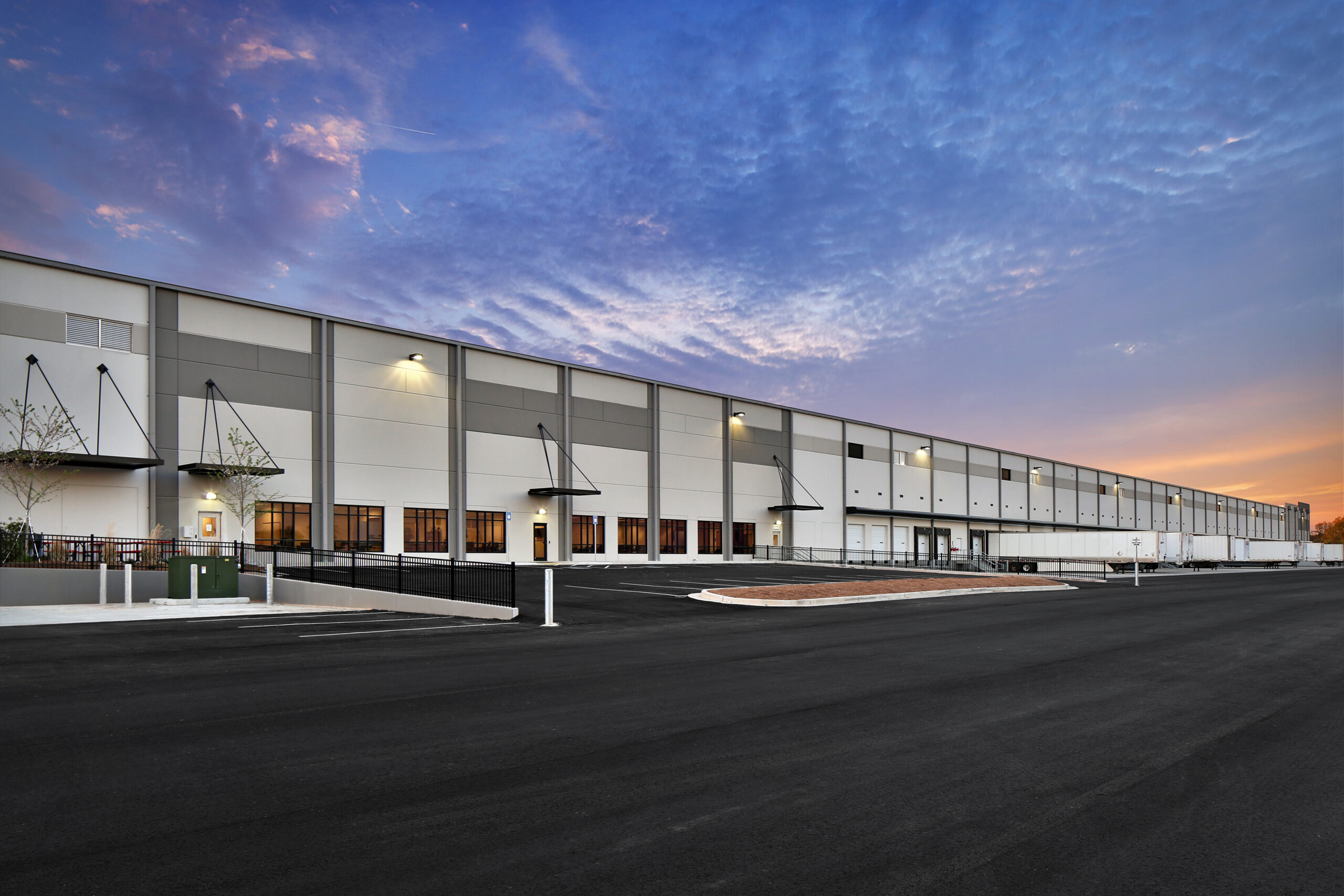 modern warehouse distribution center at sunset